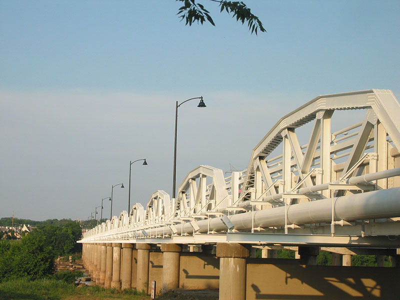 Round Tapered Prestressed Spun Concrete Pole Installation Photo Mounted on a Bridge